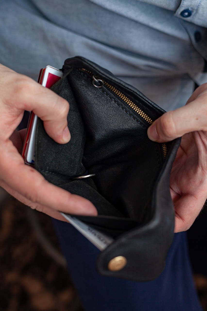 man opening empty wallet